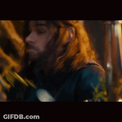 A Man With Long Hair And A Beard Is Wearing A Black Jacket . GIF