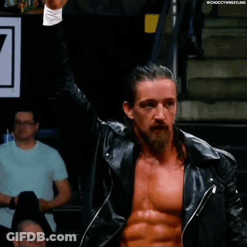 A Man With Long Hair And A Beard Is Wearing A Black Leather Jacket And Giving The Middle Finger GIF