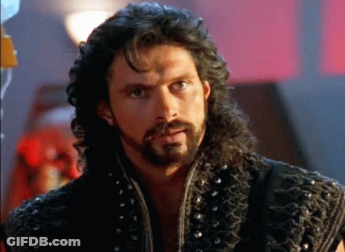Man With Long Hair And Beard In Leather Vest GIF