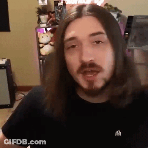 Man With Long Hair And Beard Wearing Black Shirt With Chinese Symbol GIF
