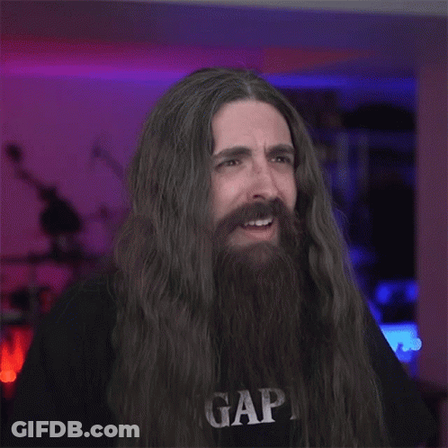 A Man With Long Hair And A Beard Is Wearing A Gap T-Shirt GIF