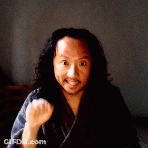 A Man With Long Hair And A Beard Is Wearing A Robe GIF