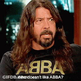 A Man With Long Hair And A Beard Is Wearing A Shirt That Says Abba GIF