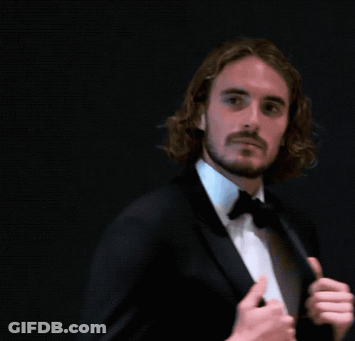 A Man With Long Hair And A Beard Is Wearing A Suit And Bow Tie GIF