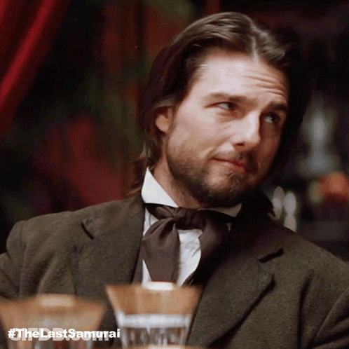 A Man With Long Hair And A Beard Is Wearing A Suit And Tie GIF