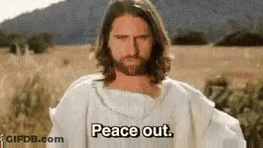 A Man With Long Hair And A Beard Is Wearing A White Robe And Saying Peace Out . GIF