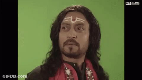 A Man With Long Hair And A Beard Is Wearing A Wig And A Headband With A Symbol On His Forehead . GIF
