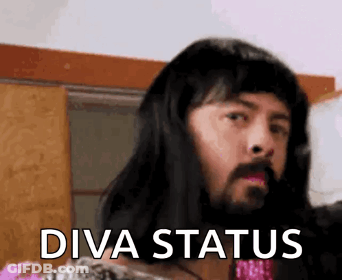 A Man With Long Hair And A Beard Is Wearing A Wig And Saying Diva Status GIF