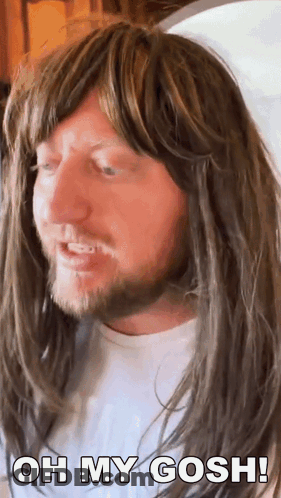 A Man With Long Hair And A Beard Is Wearing A Wig And Says Oh My Gosh ! GIF