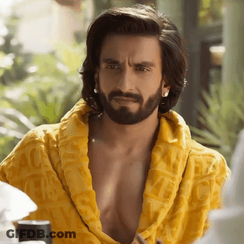 A Man With Long Hair And A Beard Is Wearing A Yellow Robe With The Word Gucci On It GIF