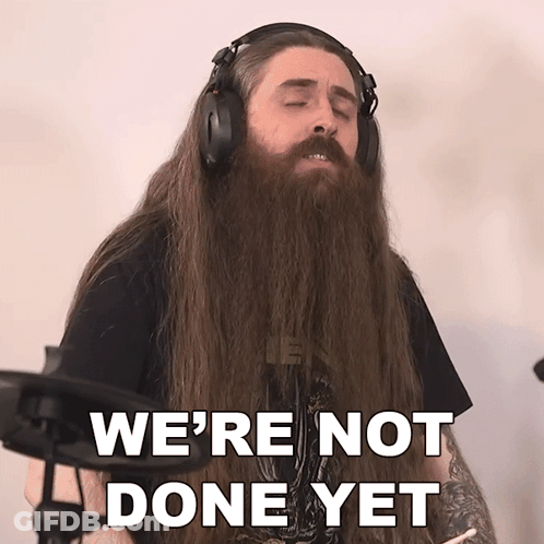 A Man With Long Hair And A Beard Is Wearing Headphones And Says We 'Re Not Done Yet GIF