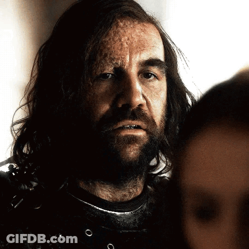 A Man With Long Hair And A Beard Looks At Another Man GIF