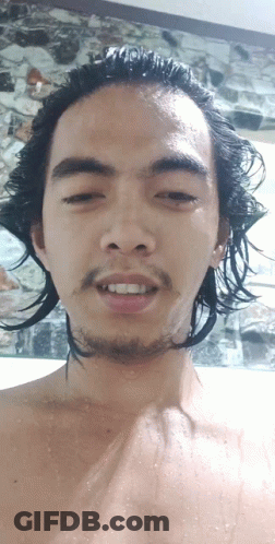 A Man With Long Hair And A Beard Looks At The Camera With His Eyes Closed GIF