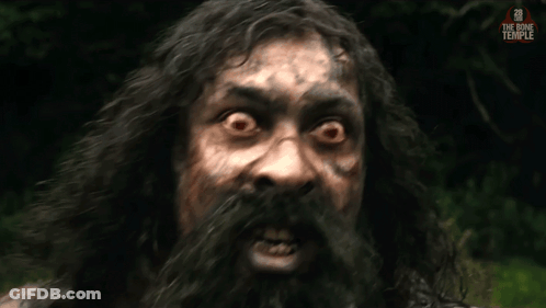 A Man With Long Hair And A Beard Looks At The Camera With The Bone Temple Written On The Bottom Right GIF