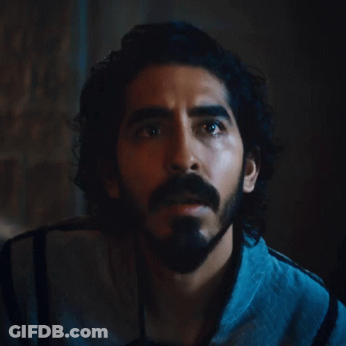 A Man With Long Hair And A Beard Looks Up At Something GIF