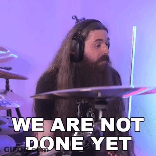 A Man With Long Hair And A Beard Playing Drums With The Words We Are Not Done Yet GIF