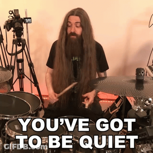 Man With Long Hair And Beard Playing Drums Saying You've Got To Be Quiet GIF