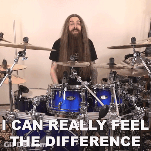 Man With Long Hair And Beard Playing Drums GIF