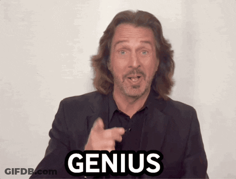 A Man With Long Hair And A Beard Points At The Word Genius GIF