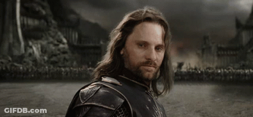 A Man With Long Hair And A Beard Says " Yolo " In White Letters GIF