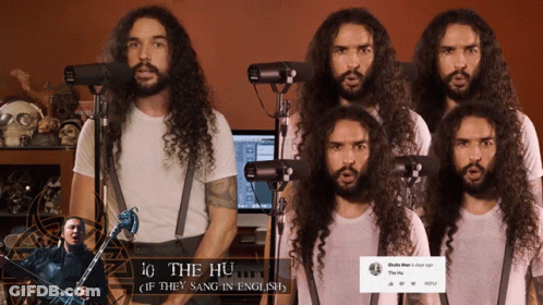 A Man With Long Hair And A Beard Singing Into Microphones GIF