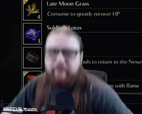 Man With Long Hair And Beard In Front Of Screen GIF