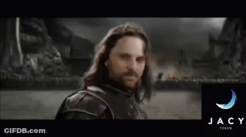 A Man With Long Hair And A Beard Stands In Front Of The Jacy Family Logo GIF