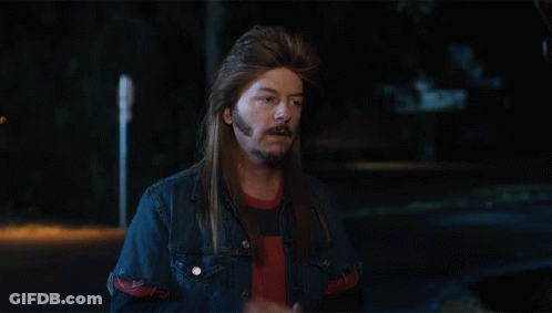 A Man With Long Hair And A Beard Wearing A Blue Denim Jacket GIF