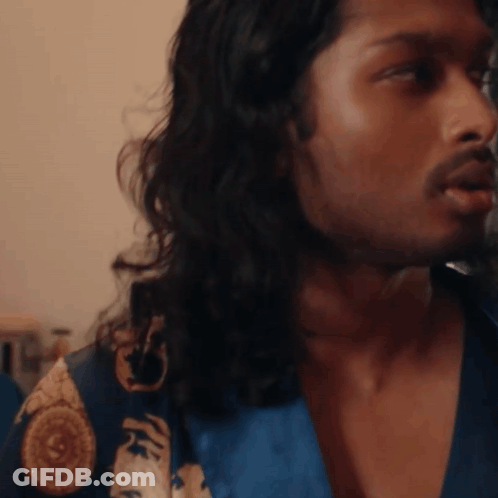 A Man With Long Hair And A Beard Wearing A Blue Robe GIF