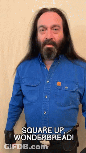 A Man With Long Hair And A Beard Wearing A Blue Shirt Says Square Up Wonderbread GIF