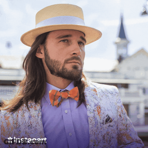 A Man With Long Hair And A Beard Wearing A Hat And Bow Tie With Instacart In The Corner GIF