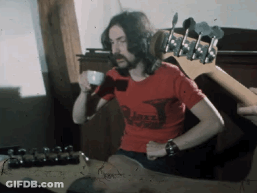 A Man With Long Hair And A Beard Wearing A Red Shirt That Says ' Jazz ' On It GIF