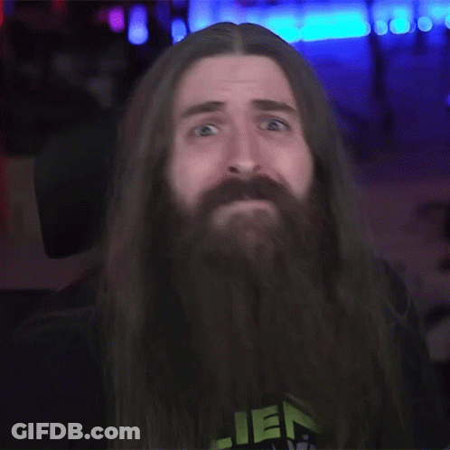 A Man With Long Hair And A Beard Wearing A Shirt That Says Alien GIF