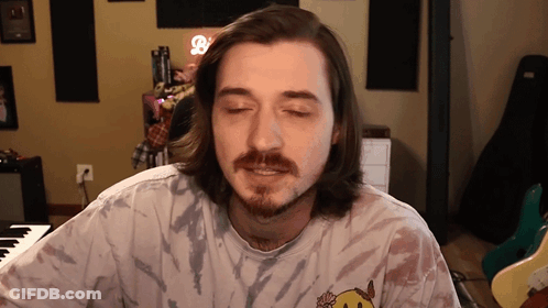 Man With Long Hair And Beard In Tie Dye Smiley Shirt GIF