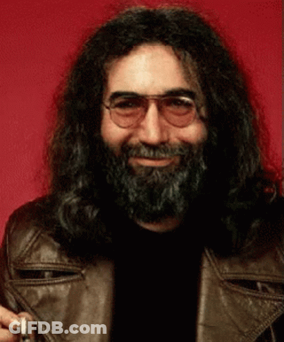 A Man With Long Hair And A Beard Wearing Glasses And A Brown Leather Jacket GIF