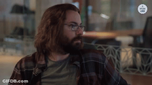 A Man With Long Hair And A Beard Wearing Glasses And A Plaid Shirt That Says Upload Link GIF