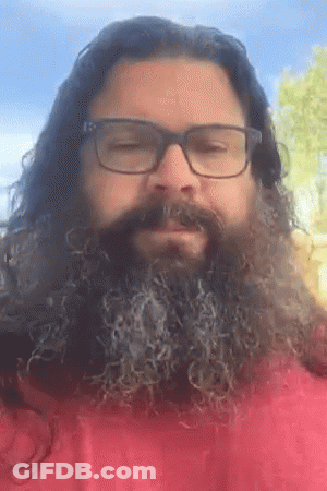 A Man With Long Hair And A Beard Wearing Glasses And A Red Shirt GIF