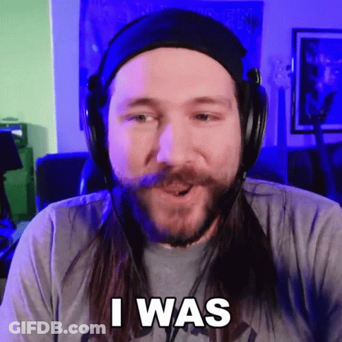 A Man With Long Hair And A Beard Wearing Headphones Says " I Was " GIF