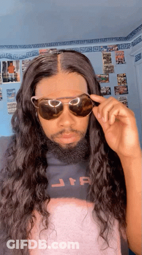 A Man With Long Hair And A Beard Wearing Sunglasses And A Star Wars Shirt GIF