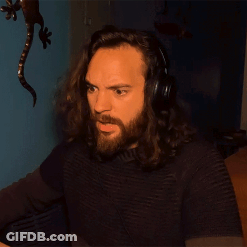 A Man With Long Hair And A Beard Wears Headphones GIF