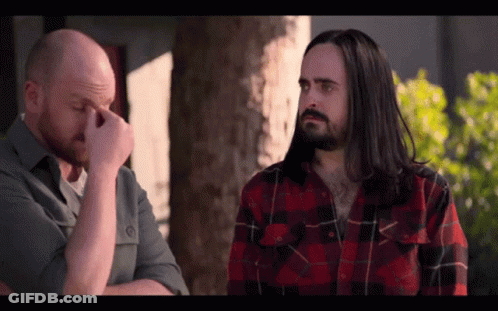 Man With Long Hair And Beard Wipes Nose GIF