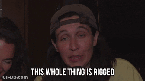A Man With Long Hair And A Hat Is Saying This Whole Thing Is Rigged GIF