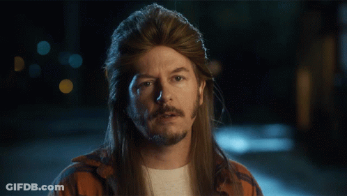 A Man With Long Hair And A Mullet Is Looking Down With His Eyes Closed GIF