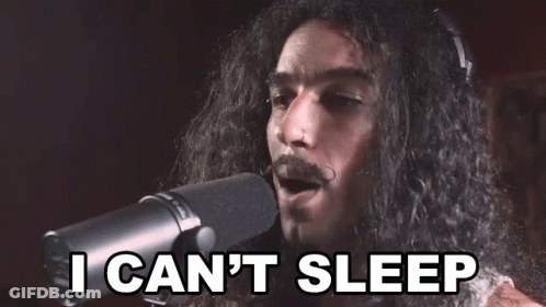 A Man With Long Hair And A Mustache Is Singing Into A Microphone And Saying `` I Can 'T Sleep '' . GIF