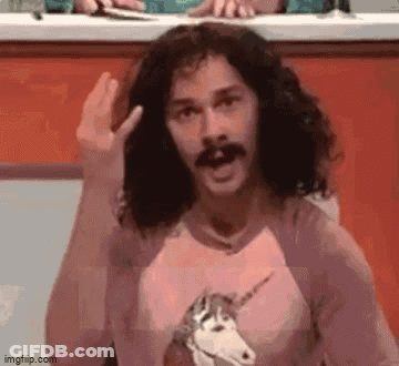 A Man With Long Hair And A Mustache Is Wearing A Unicorn Shirt And Making A Funny Face . GIF