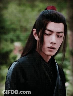 A Man With Long Hair And A Red Ponytail GIF