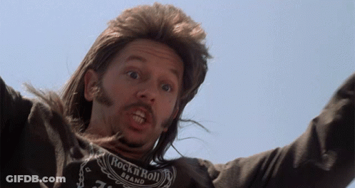 A Man With Long Hair And A Rock N Roll Shirt On GIF