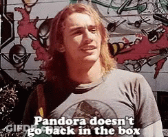 A Man With Long Hair And A T-Shirt That Says Pandora Does N't Go Back In The Box . GIF