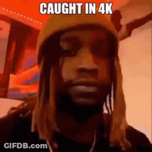 A Man With Long Hair And Dreadlocks Is Wearing A Yellow Hat And A Mask . GIF