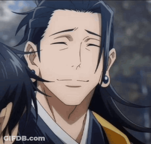 A Man With Long Hair And Earrings Is Smiling And Looking At The Camera . GIF